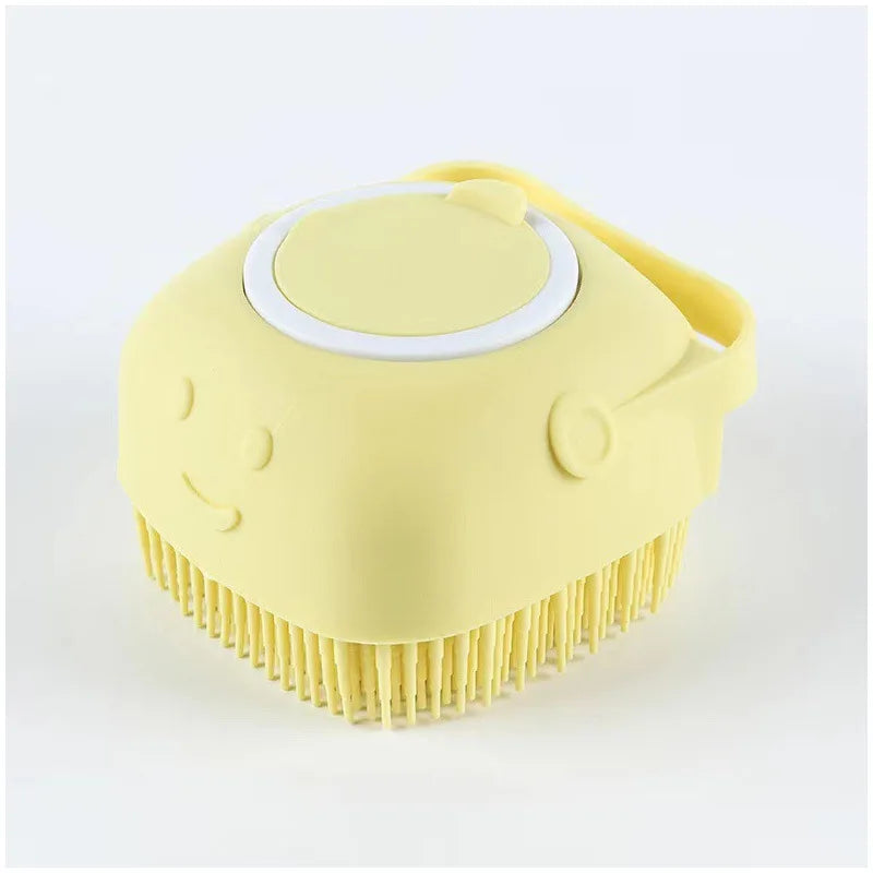 Yellow pet grooming brush with a smiley face design on a white background