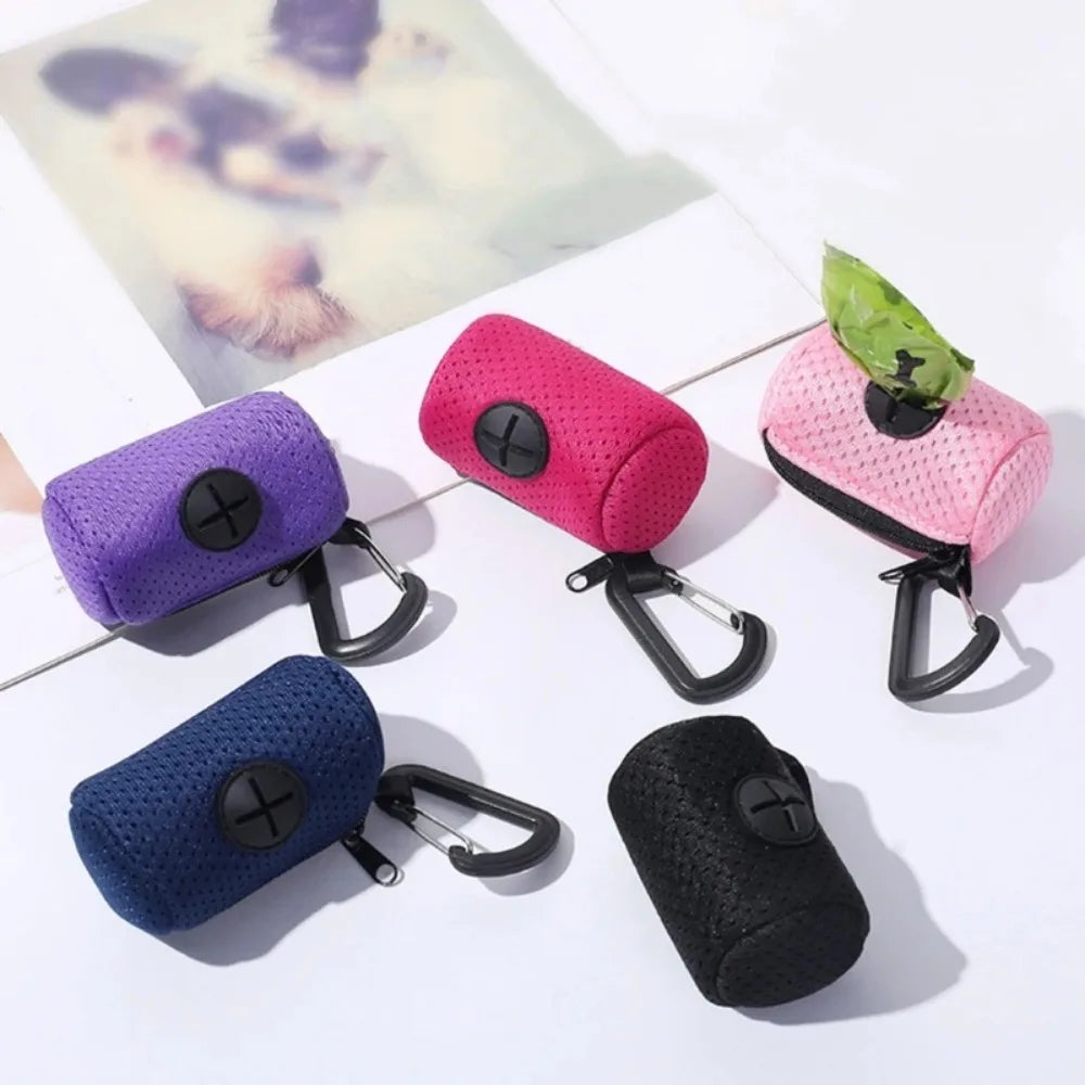 Colorful keychain pouches on a white surface with a blurred photo in the background.