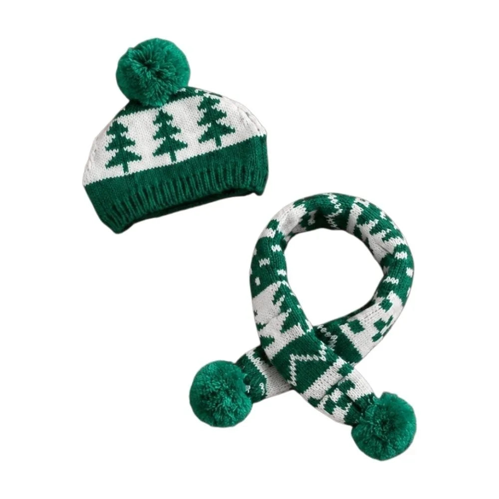 A matching knit winter set featuring a beanie hat and a scarf, both in green and white with a Christmas tree pattern. The beanie has a green pom-pom, and the scarf has two green pom-poms at the ends.