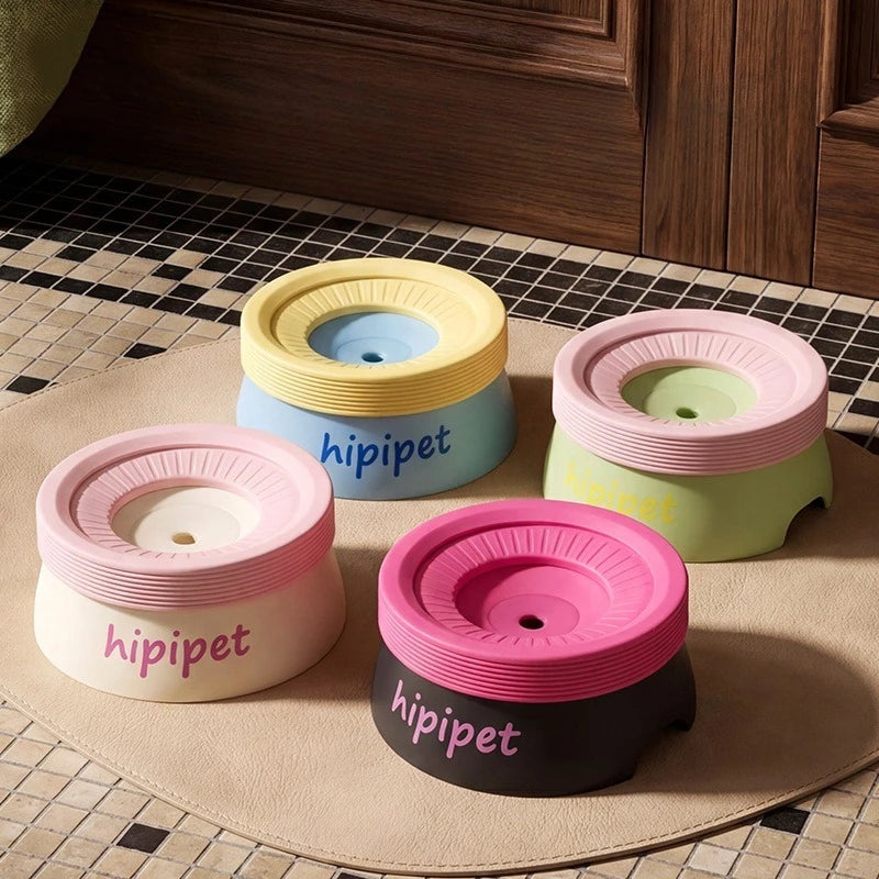 Four hip joint support pet bowls in pastel colors (pink, yellow, light blue, and dark pink) arranged on a round beige mat on a tiled floor.