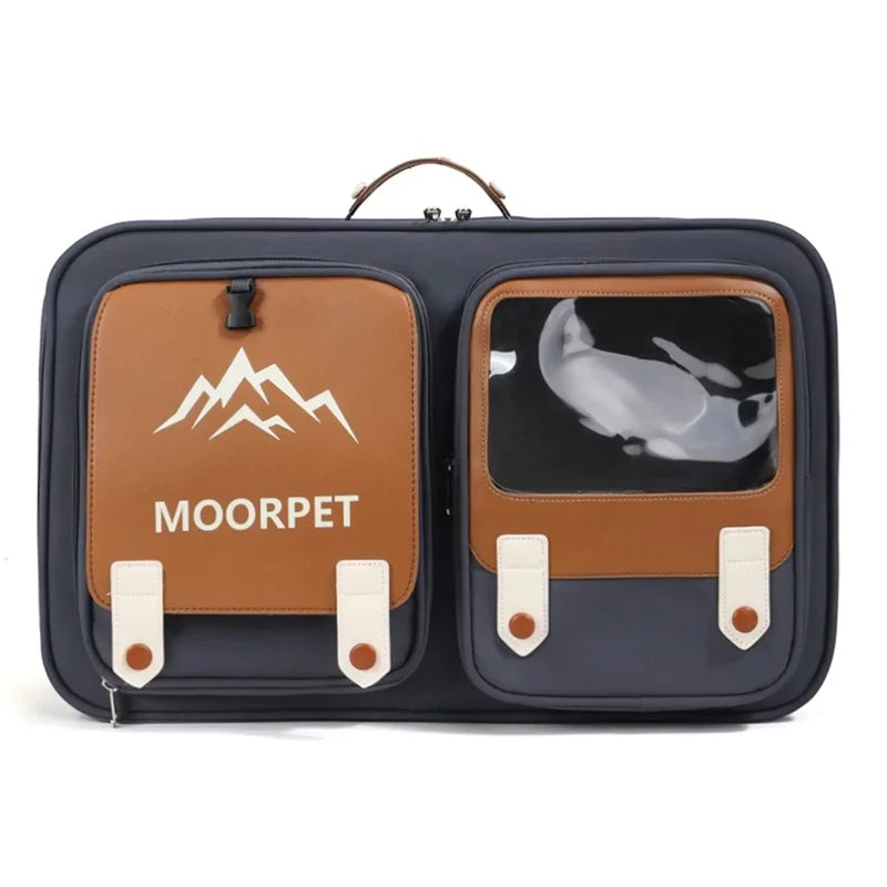 A pet travel bag with a dark navy blue body and tan accents, featuring a top handle, a left zippered pocket with a white mountain logo and 'MOORPET' text, and a right pocket with a clear window showing a white cat inside.