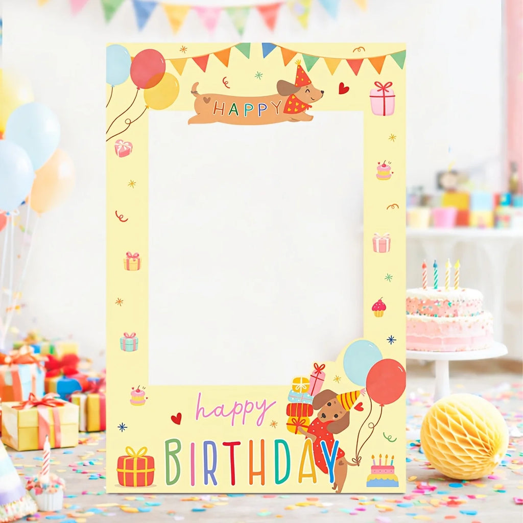 A pastel yellow birthday photo frame with cartoon dog illustrations, colorful balloons, gift boxes, and the words 'HAPPY BIRTHDAY' displayed in a party setting with confetti and a cake in the background.