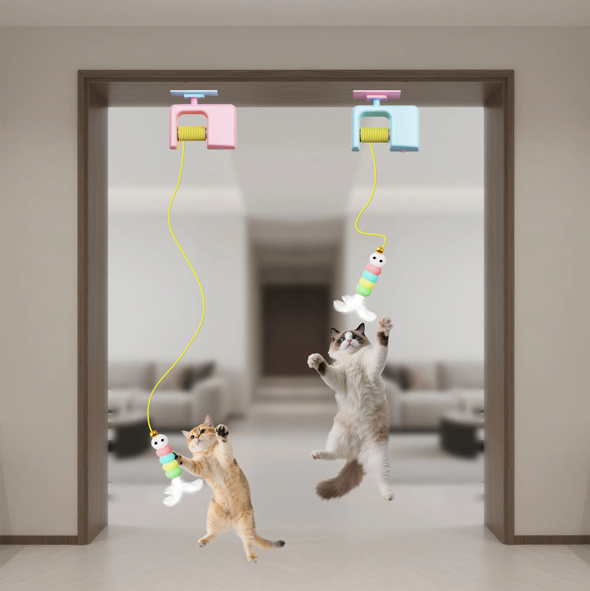 Two cats playing with hanging cat toys in a room.