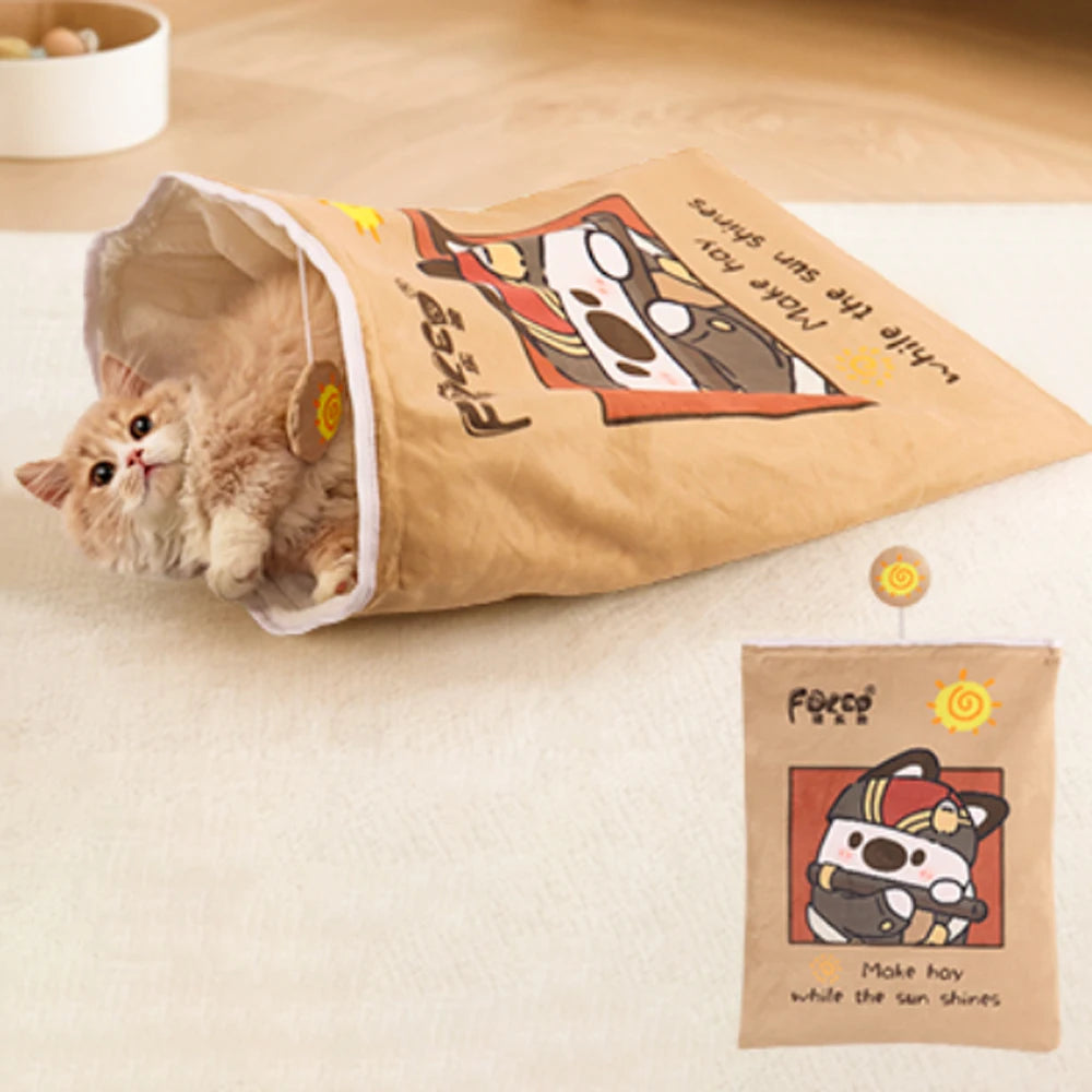 Cat playing with a paper tunnel toy on a wooden floor