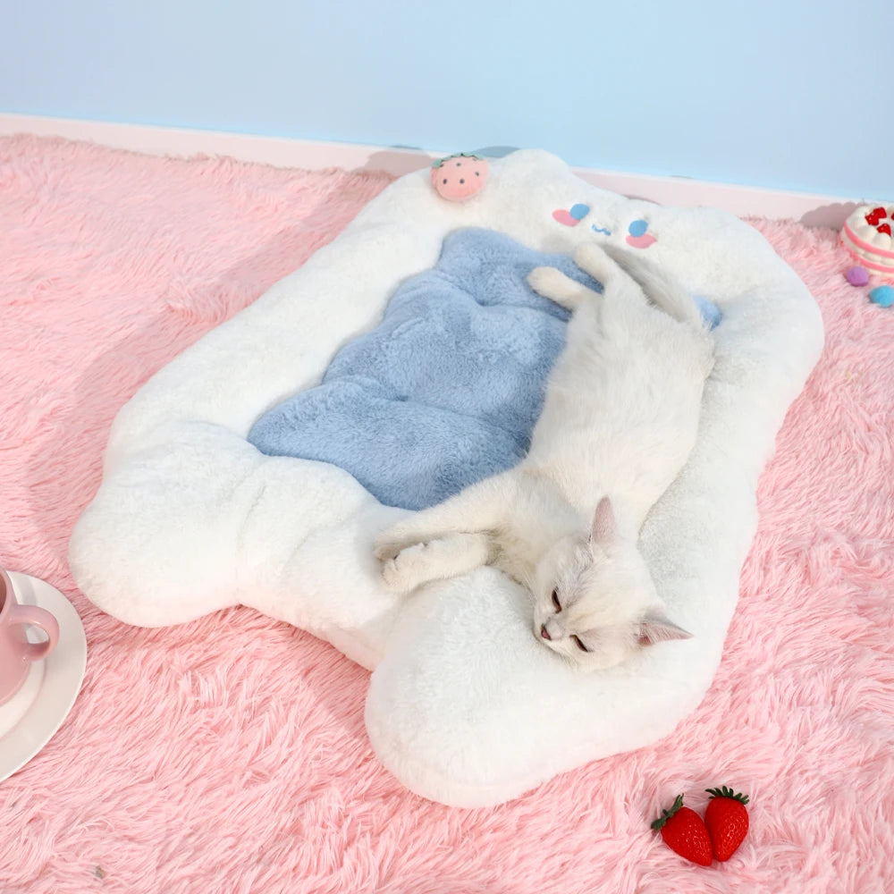 White cat lying on a fluffy pink and blue pet bed with a light blue background.