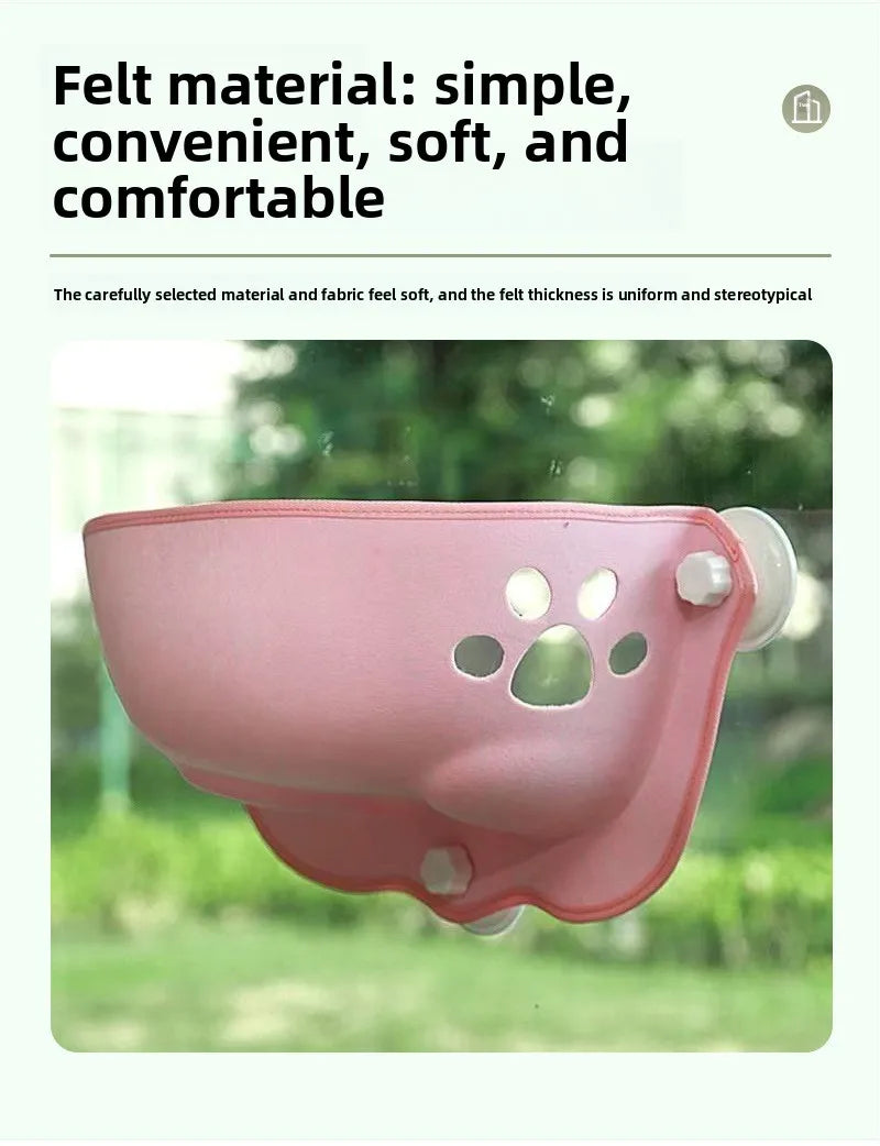 A pink felt pet window screen with suction cups, shown mounted on a glass window with a blurred green garden background. The image includes marketing text at the top describing the felt material as simple, convenient, soft, and comfortable.