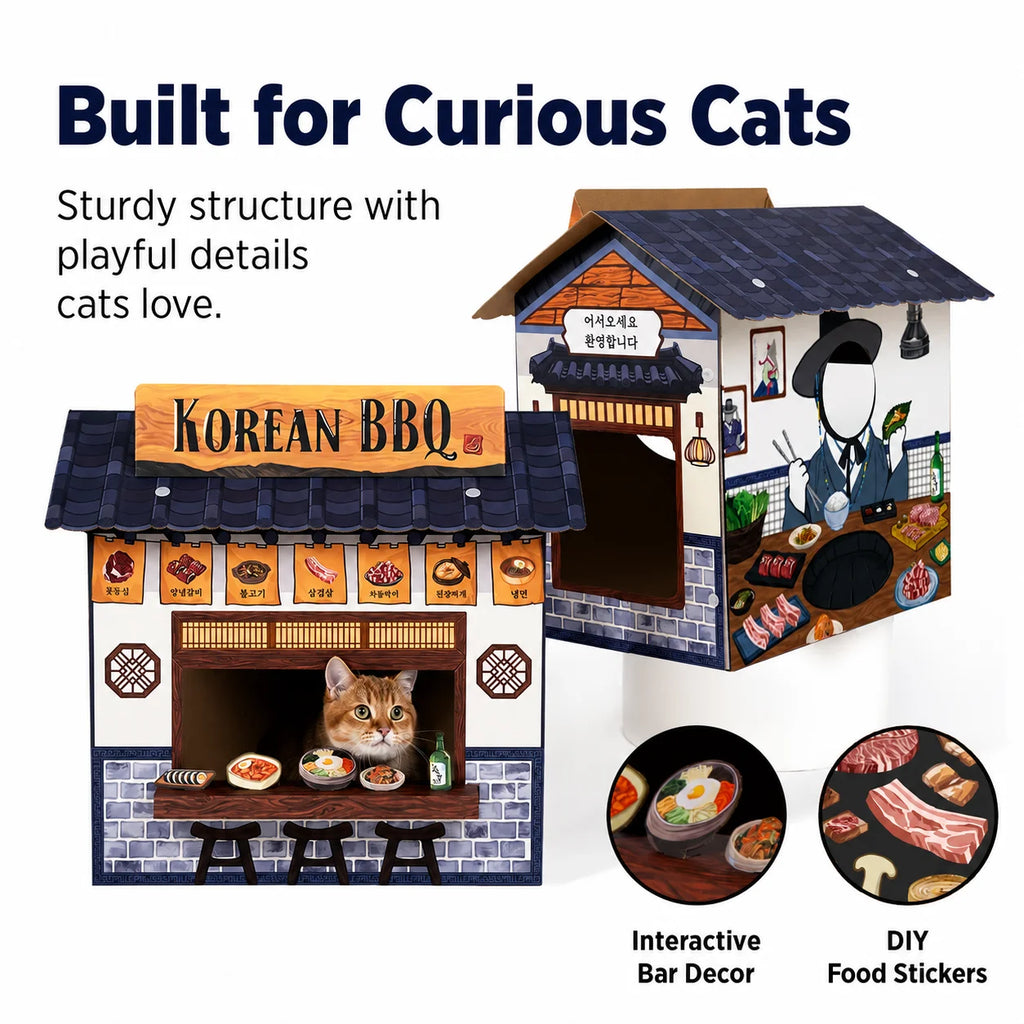 A miniature Korean BBQ dog house toy shown from two angles on a white background, with a cat peeking out of the window on the front view. Text reads 'Built for Curious Cats' and includes feature callouts 'Interactive Bar Decor' and 'DIY Food Stickers'.