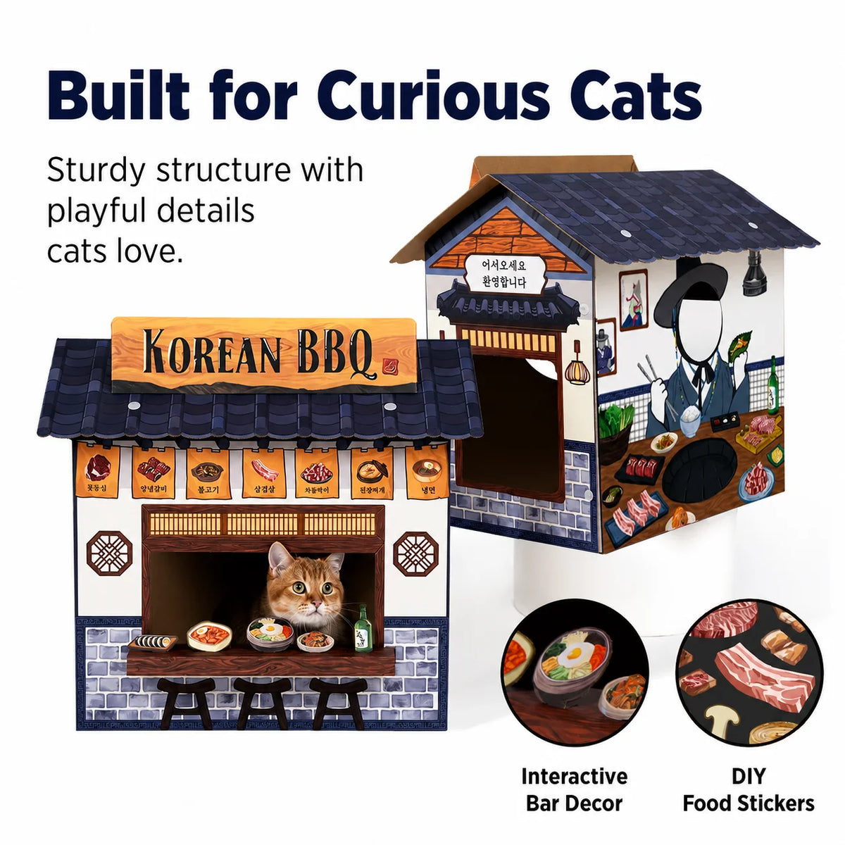 A miniature Korean BBQ dog house toy shown from two angles on a white background, with a cat peeking out of the window on the front view. Text reads 'Built for Curious Cats' and includes feature callouts 'Interactive Bar Decor' and 'DIY Food Stickers'.