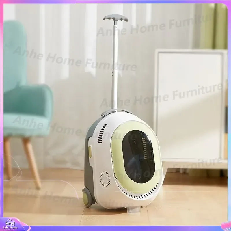 A wheeled pet carrier with an extendable handle, shown in a home interior setting. The carrier has a white body with a pale yellow-green circular accent and a dark window, with a gray side panel and wheels.