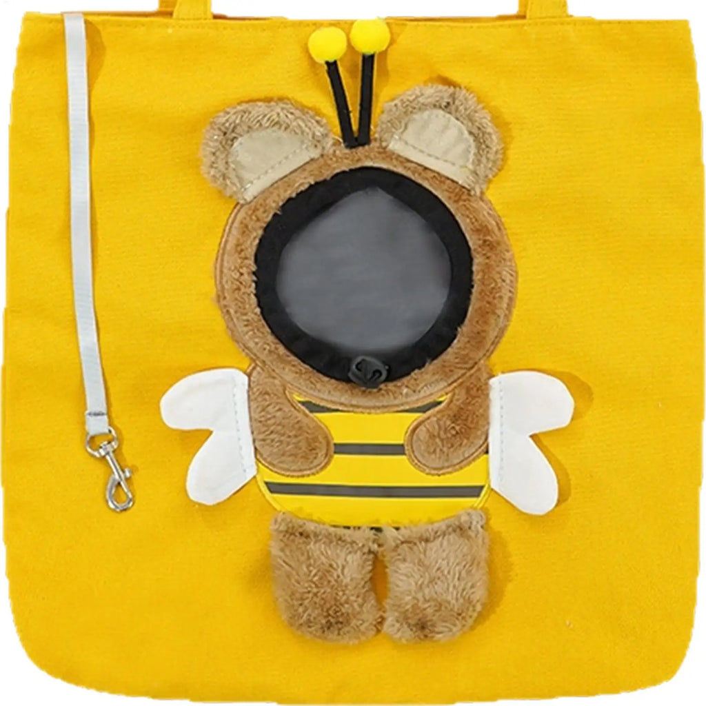 A bright yellow fabric tote bag featuring a plush bee character applique on the front. The bee has brown fuzzy body and head, white wings, a yellow and black striped body, and black antennae with yellow pom-poms.