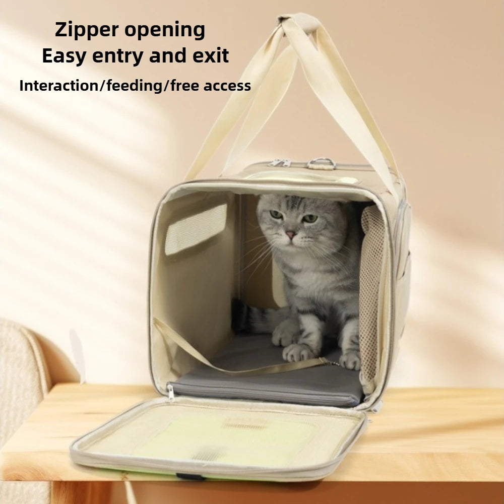 A gray cat sits inside a beige pet carrier bag with the front zipper opening down, placed on a wooden table. Text at the top reads 'Zipper opening Easy entry and exit Interaction/feeding/free access'.