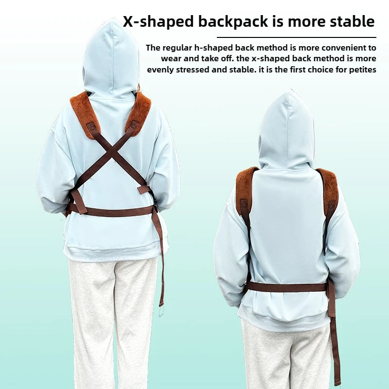 Two children shown from the back wearing a light blue hoodie and white sweatpants, with a brown X-shaped harness backpack strap system across their backs. Text at the top explains the X-shaped backpack method.