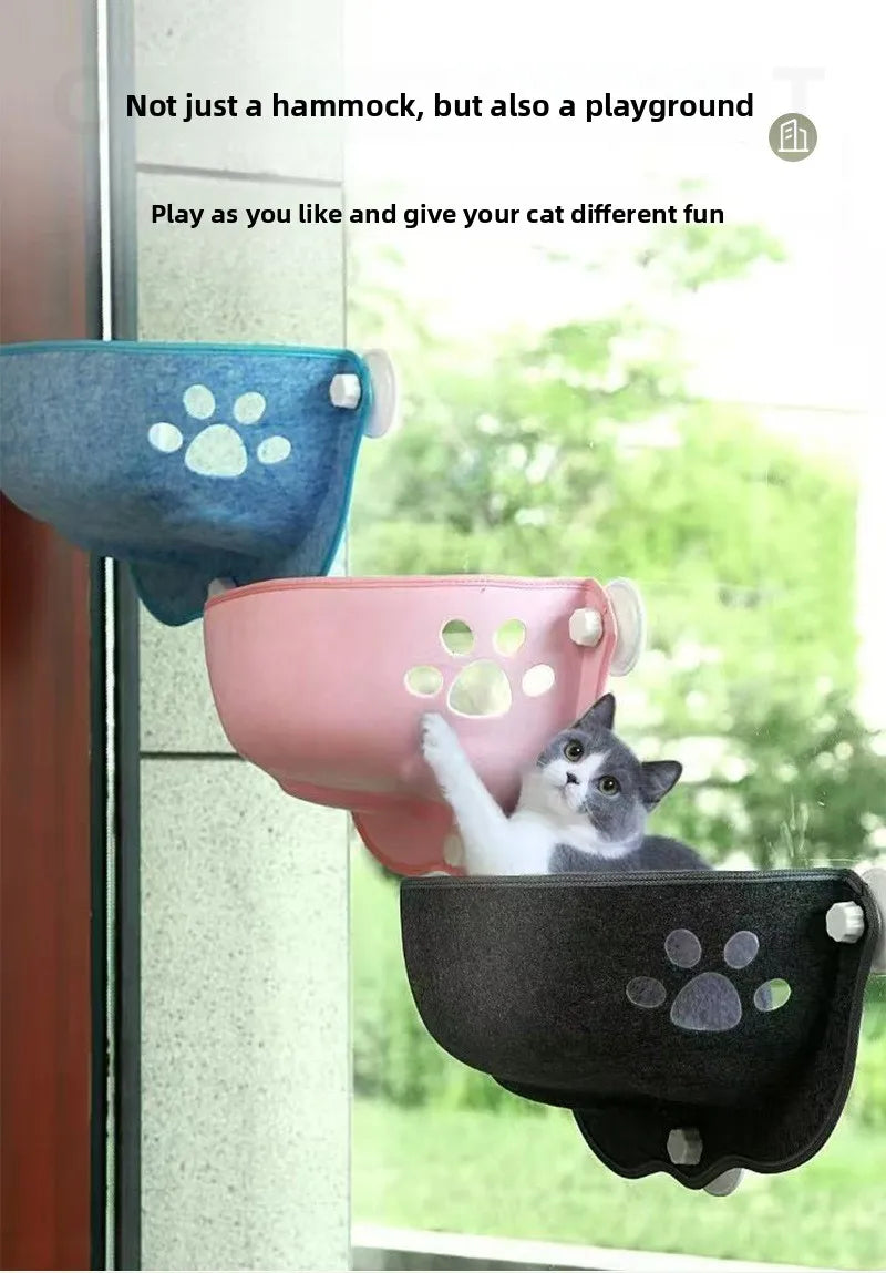 Three wall-mounted cat hammocks in blue, pink, and black are shown hanging near a window, with a gray-and-white cat sitting in the black hammock. Text at the top reads, 'Not just a hammock, but also a playground' and 'Play as you like and give your cat different fun.