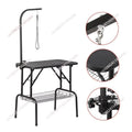 Black metal grooming table with an arm bar, hanging leash, textured top surface, lower wire basket, and three circular detail insets showing close-ups of hardware, the textured seat, and the adjustment bracket.