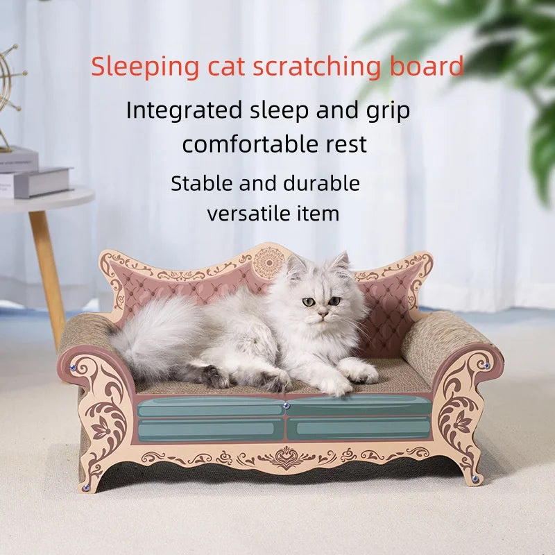 A fluffy white cat lies on an ornate miniature cardboard cat sofa with pink tufted upholstery and carved floral details, set in a bright indoor room with curtains and a side table in the background.
