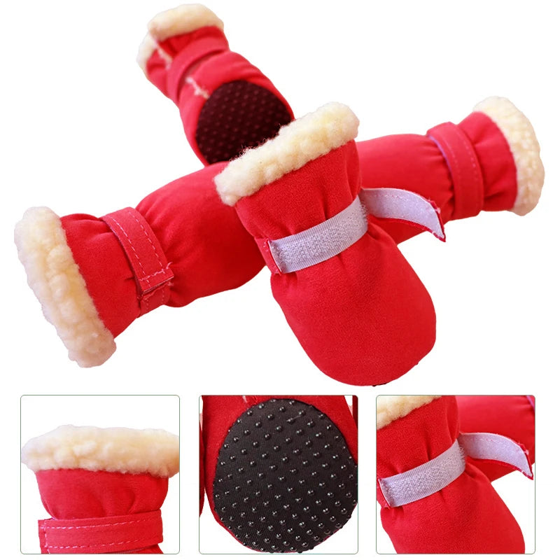 Red pet paw warmers with fur lining and white straps on a white background.