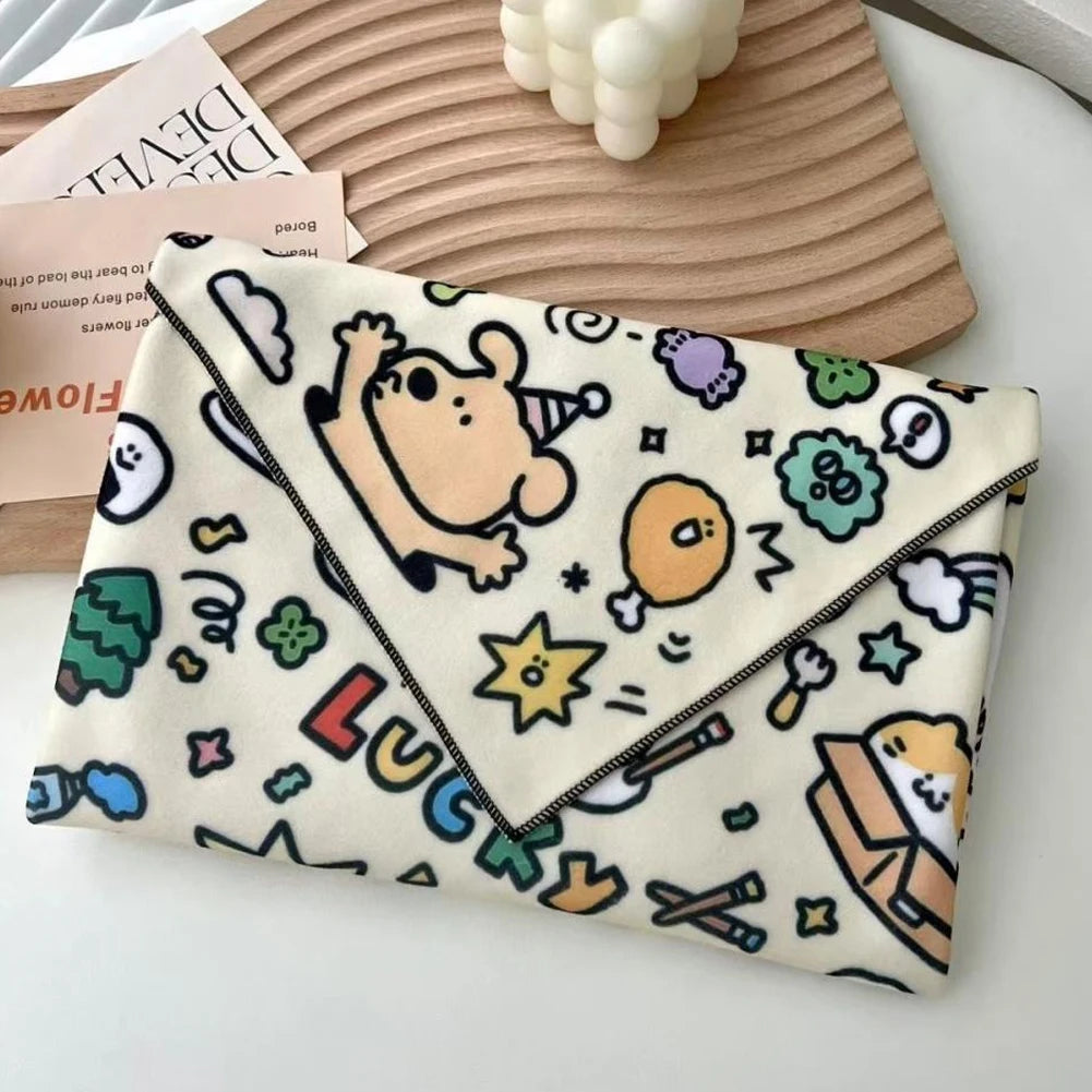Folded blanket with cartoon character and text on a wooden surface