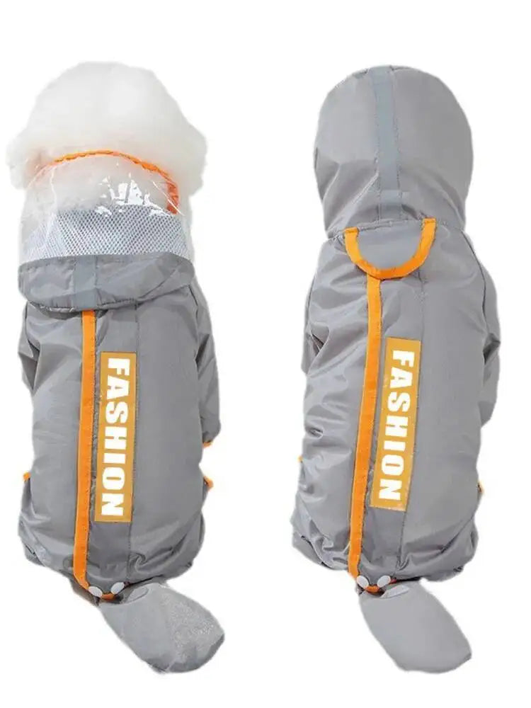 A gray dog winter coat shown from two angles on a white background. The coat features a hood, a white faux-fur trim at the neck, a mesh face panel, and bright orange accents including a vertical zipper with 'FASHION' text and a top handle.