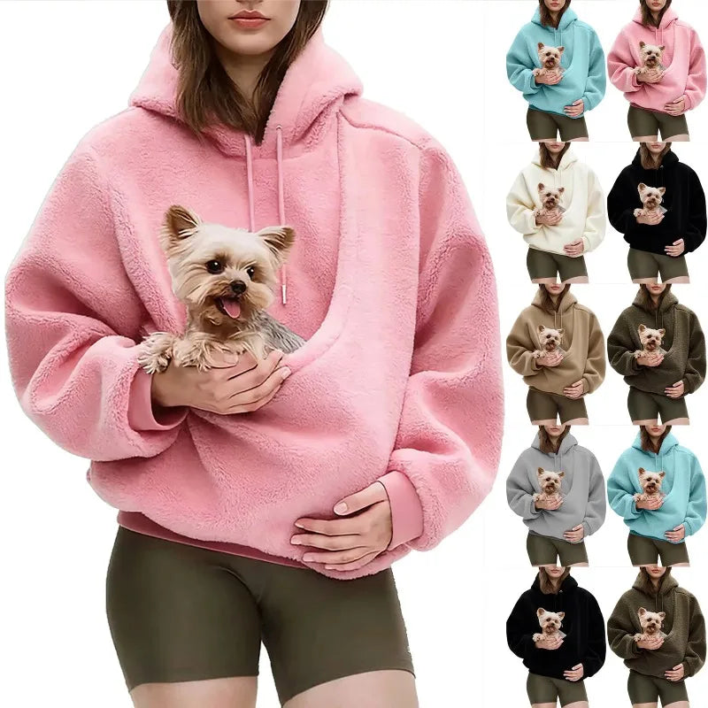 Person wearing a pink hoodie holding a small dog, with multiple color options displayed.