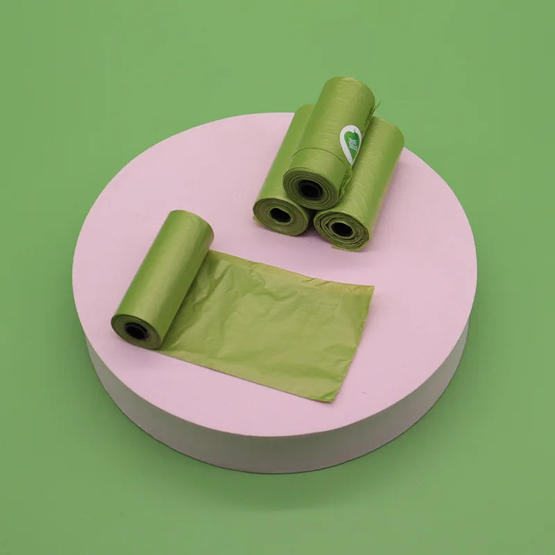 Green plastic bags on a pink platform with a green background