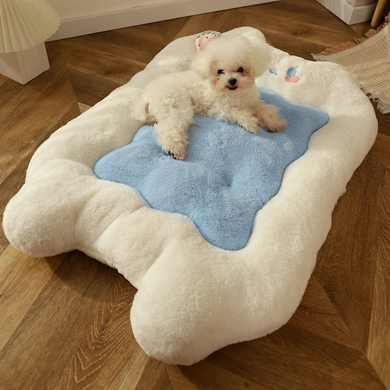 Dog lying on a bone-shaped pet bed with a blue cushion on a wooden floor.
