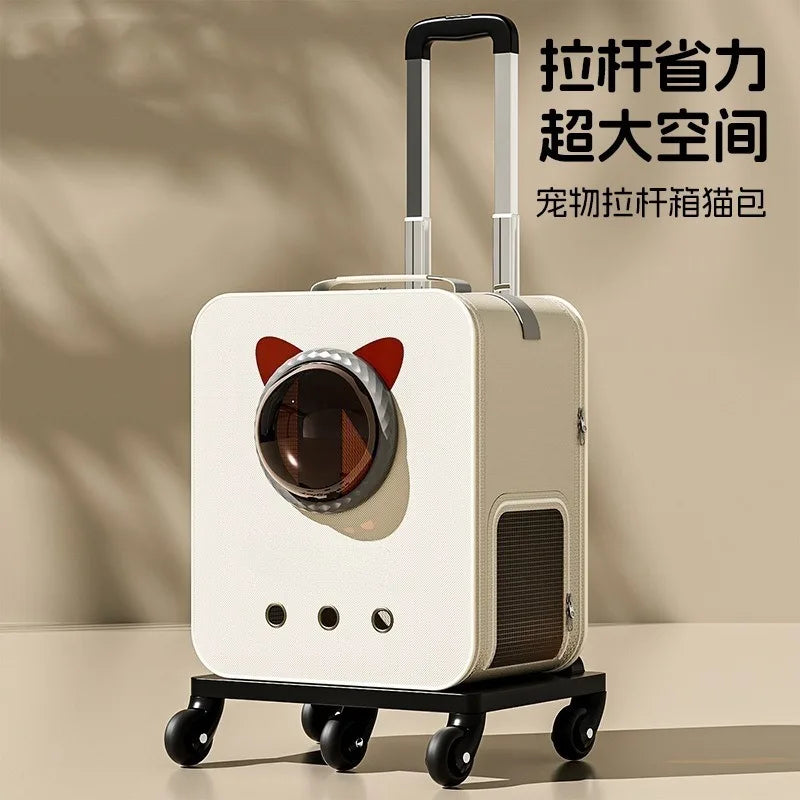 A cream-colored pet cat suitcase with a retractable handle and four wheels, featuring a cat-ear design around the front window. The image includes Chinese promotional text in the upper right corner.