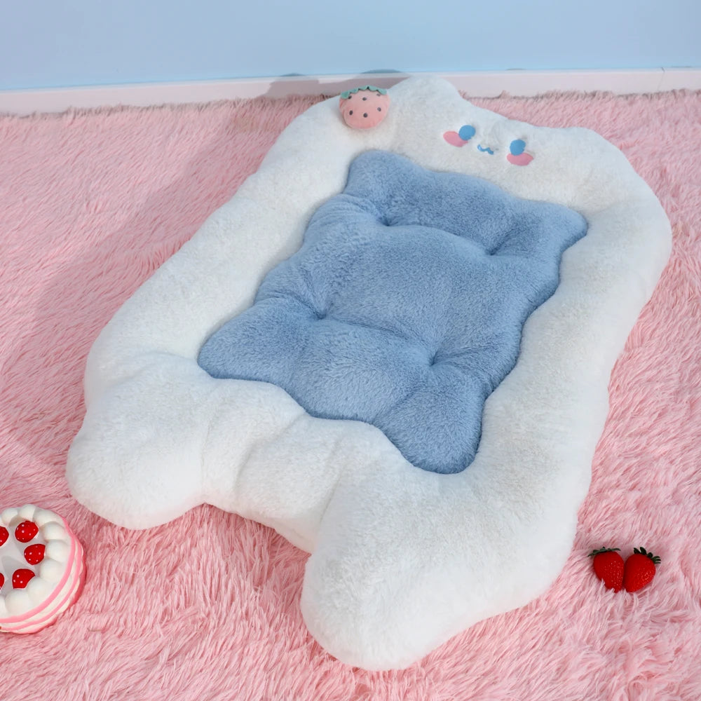 Blue plush toy with white cloud-shaped pillow on a pink surface