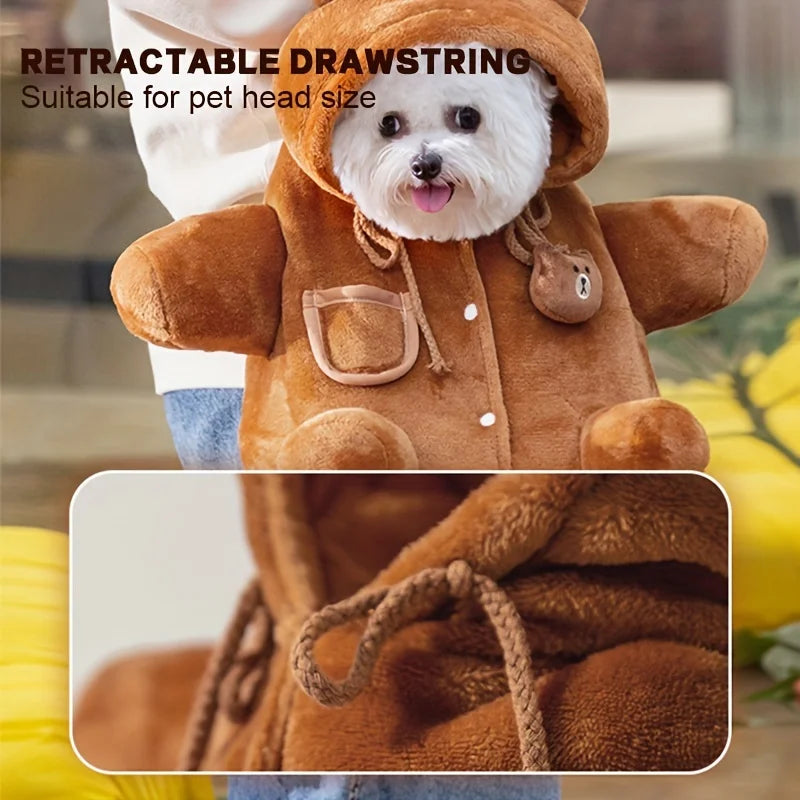 A small white dog wearing a brown plush teddy bear hooded pet jacket with drawstrings and front pocket, shown with text reading 'RETRACTABLE DRAWSTRING Suitable for pet head size' and a close-up inset of the drawstring detail.