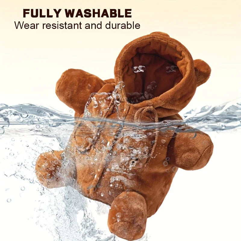 A brown plush teddy bear wearing a hooded sweatshirt is shown partially submerged in splashing water, with text reading 'FULLY WASHABLE Wear resistant and durable' on a light beige background.