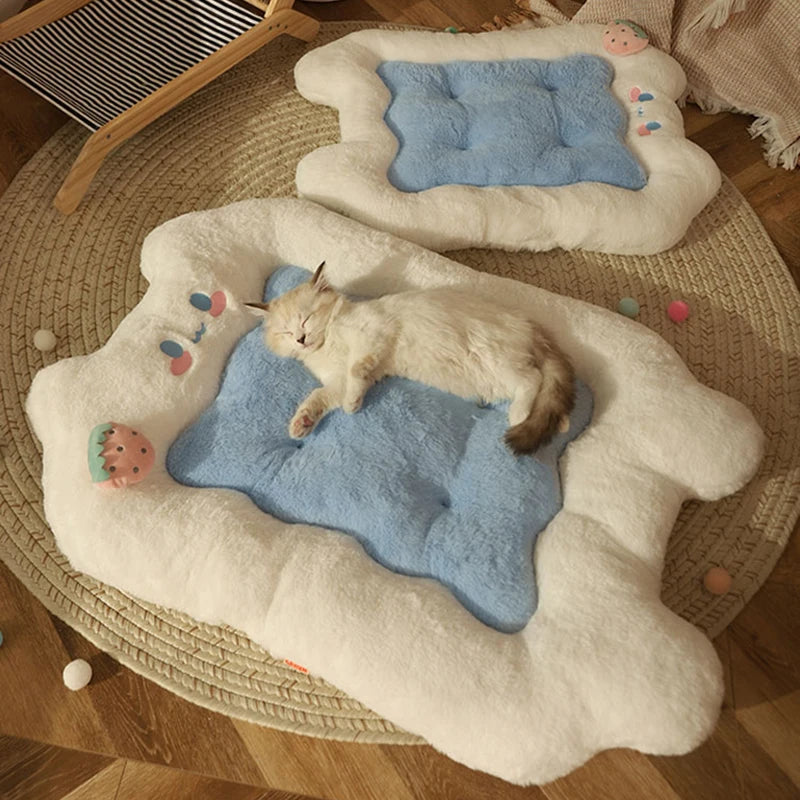 Cat lying on a cloud-shaped pet bed with a blue cushion on a wooden floor.