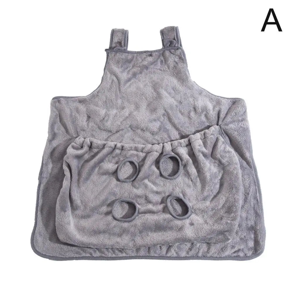 A gray plush fleece baby bib or apron-style cover with shoulder straps and four circular ring details on the front, shown flat against a white background with a black letter A in the top right corner.