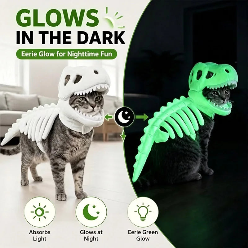 A cat wearing a dinosaur skeleton costume in a split comparison: on the left, the cat stands in a bright room wearing a white skeleton costume that absorbs light; on the right, the cat sits in a dark room wearing the same costume glowing bright green. Large text reads 'GLOWS IN THE DARK' with icons for absorbing light, glowing at night, and eerie green glow.