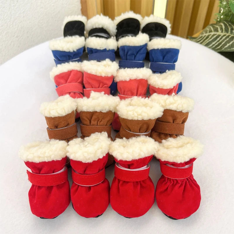 Stack of pet boots in red, blue, and brown with white fur on a white surface.