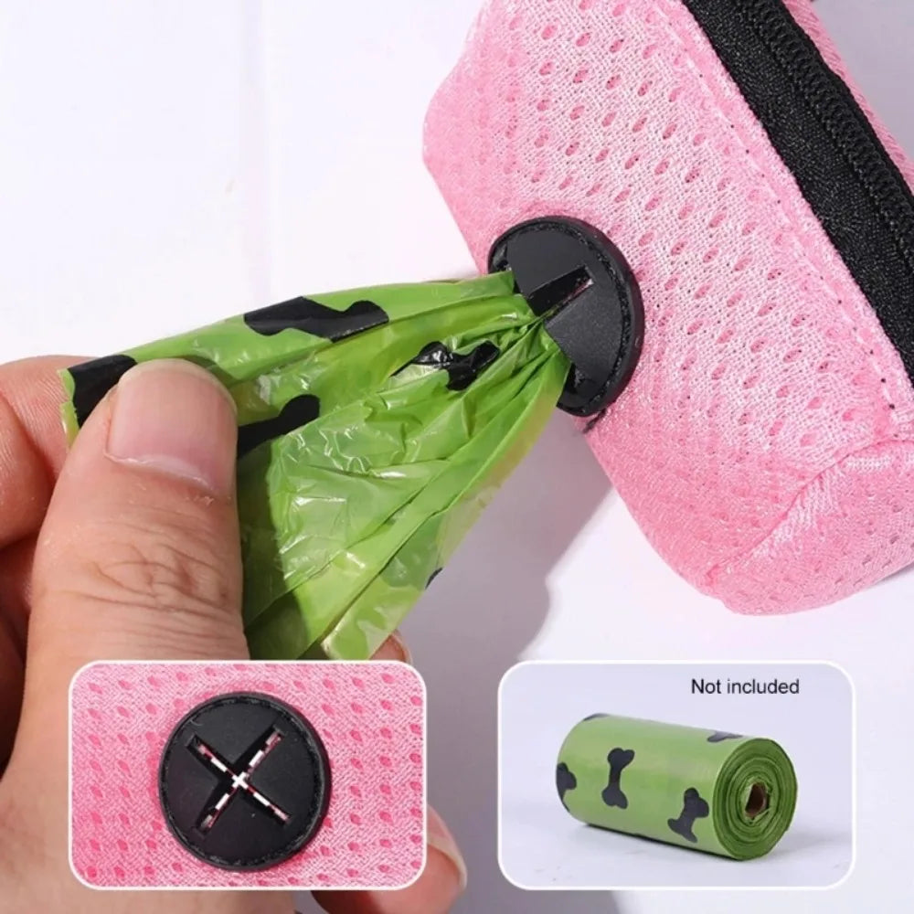 Pink mesh bag with black zipper and green plastic bags, with a hand holding a green plastic bag.