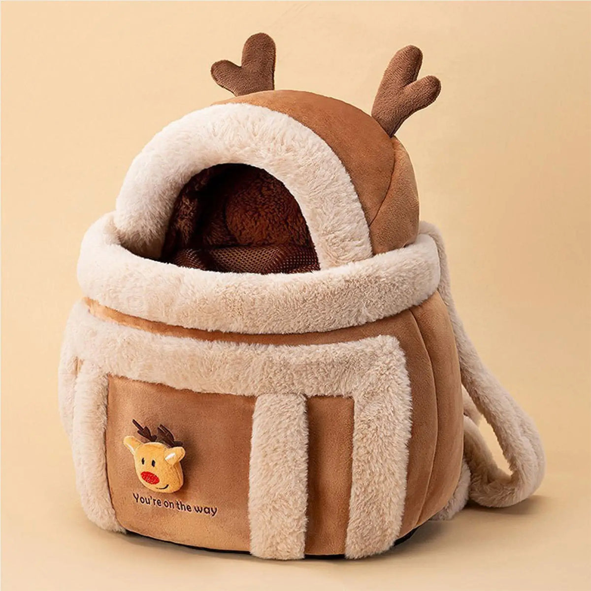 pet's winter backpack with reindeer design on a beige background