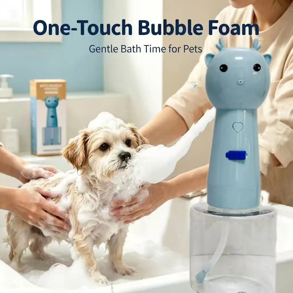 A small dog standing in a bathtub with soap foam while a person washes it. A light blue one-touch bubble foam device for pets is shown in the foreground on a clear base, with text reading 'One-Touch Bubble Foam' and 'Gentle Bath Time for Pets.