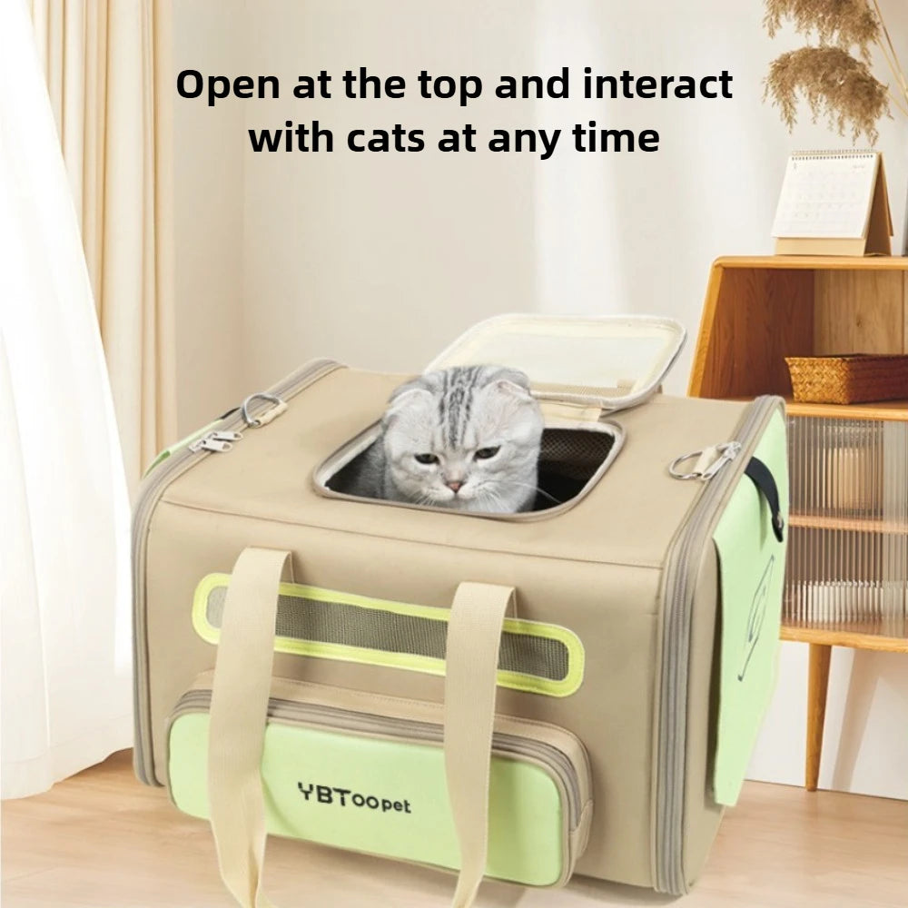 A beige and light green pet carrier bag with a gray cat peeking out from the top opening, set in a home interior with text overlay that reads 'Open at the top and interact with cats at any time.' The bag has dual handles and a front pocket with the brand name 'YBTooPet' visible.