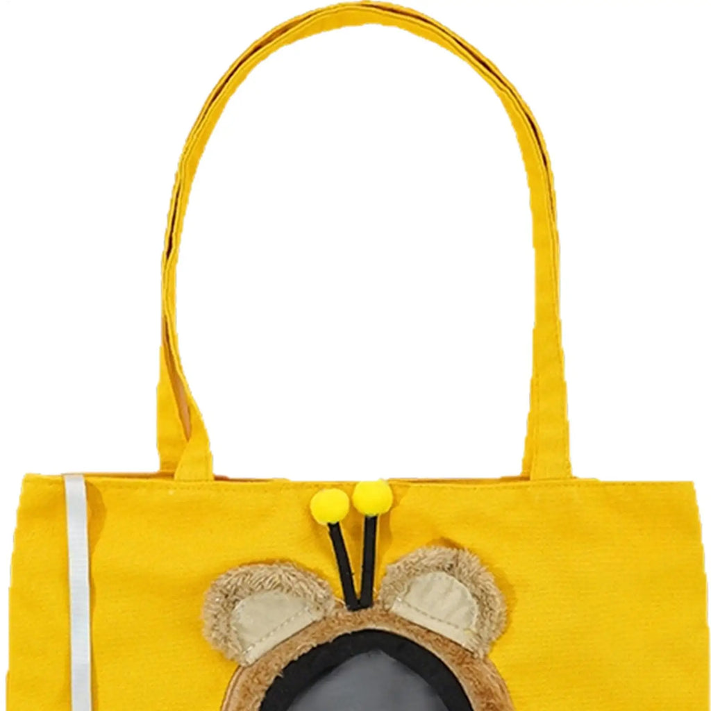 A bright yellow fabric tote bag featuring a cute bee character design on the front, complete with embroidered brown and beige wings, black antennae, and two yellow pom-poms, set against a plain white background.