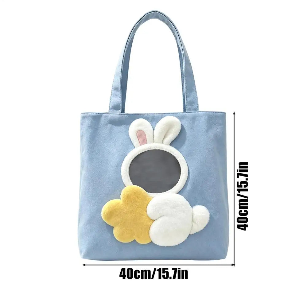 A light blue fabric tote bag with a bunny applique design on the front, shown with black measurement lines and text indicating dimensions of 40cm/15.7in width and 40cm/15.