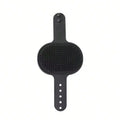 A black silicone pet grooming brush with a textured bristle pad and adjustable handle, shown against a plain white background.
