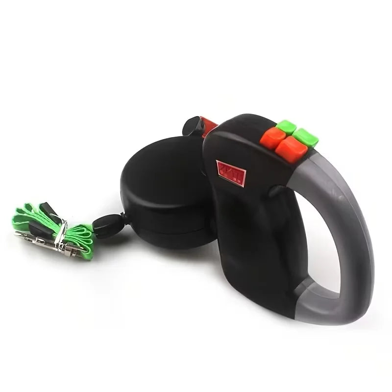 Black retractable dog leash with green and red accents on a white background
