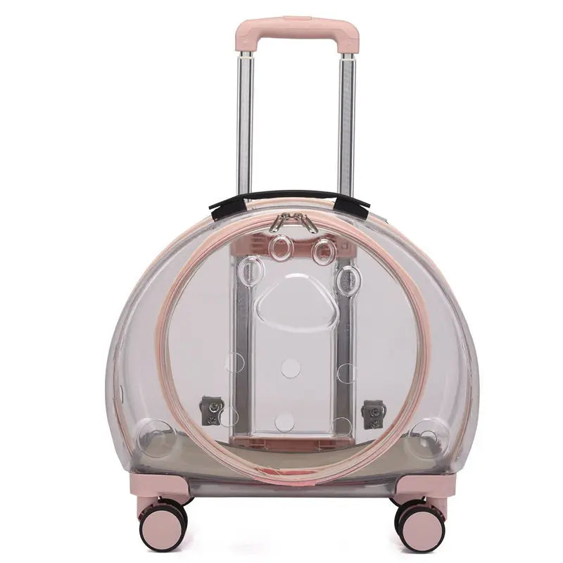 A clear plastic cat carrier rolling suitcase with a pink handle, pink trim, and four wheels, shown on a white background.