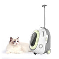 A white and gray rolling cat carrier with wheels and an extendable handle, shown next to a fluffy white cat with blue eyes on a clean white background.
