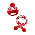 A red and white knit baby winter hat and matching scarf set with snowflake patterns and red pom-poms, shown on a plain white background.