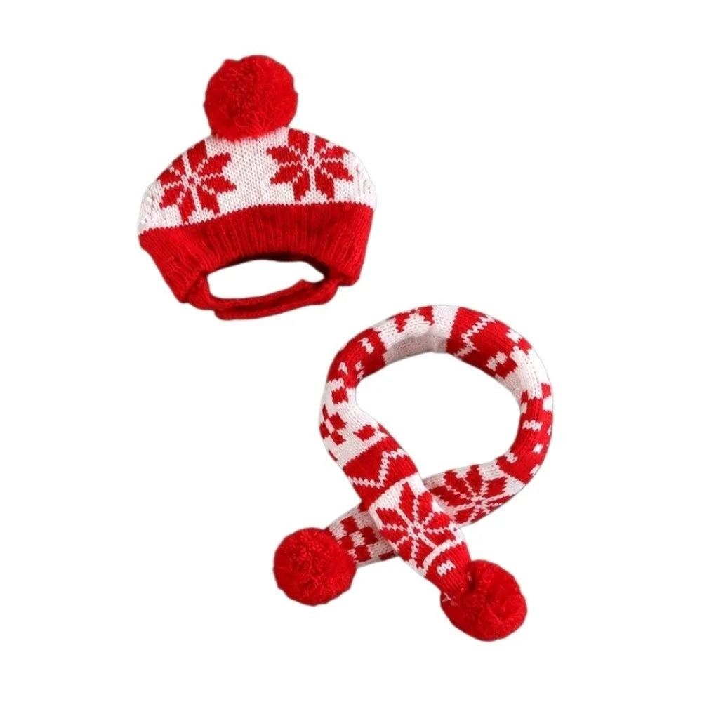 A red and white knit baby winter hat and matching scarf set with snowflake patterns and red pom-poms, shown on a plain white background.