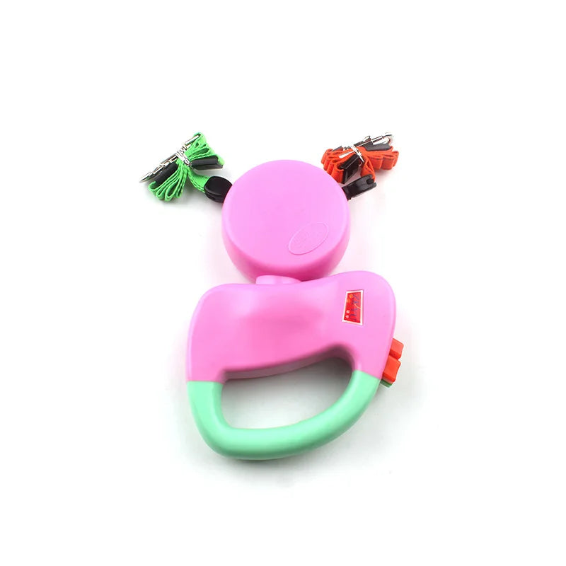 Pink and green dog double leash with a handle on a white background