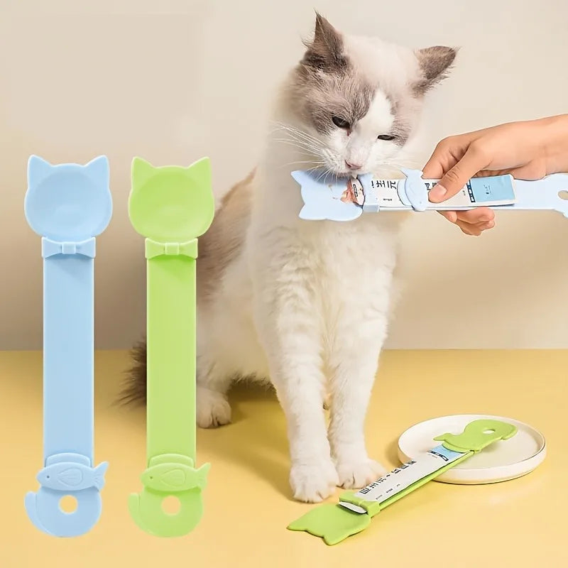 Cat using a blue and green cat-shaped tool with a person assisting.