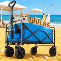 A blue and black foldable wagon cart with large black wheels, shown on a sandy beach with a dog inside and beach umbrellas, surfboards, and the text '360LBS' in the background.