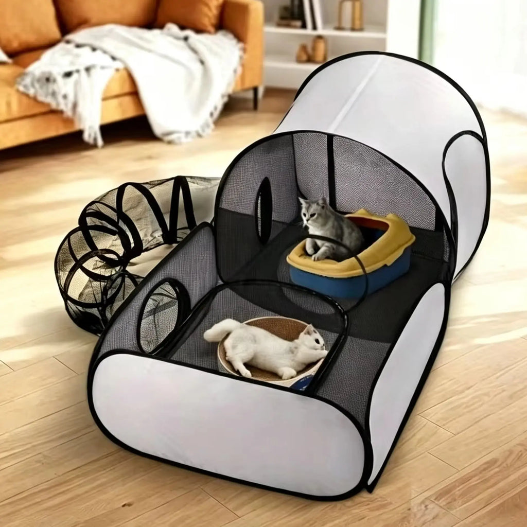 A pop-up cat play tent with mesh walls and a tunnel, shown in a living room with two cats inside. The tent has a white and black color scheme, and the scene is set on a light wood floor with a sofa in the background.